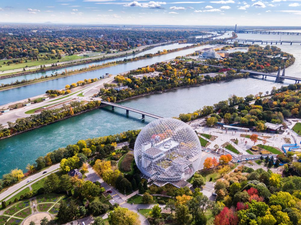 For a piece on the best time to visit Montreal, an aerial photo of the Biosphere Museum and the Saint Lawrence River during the Fall
