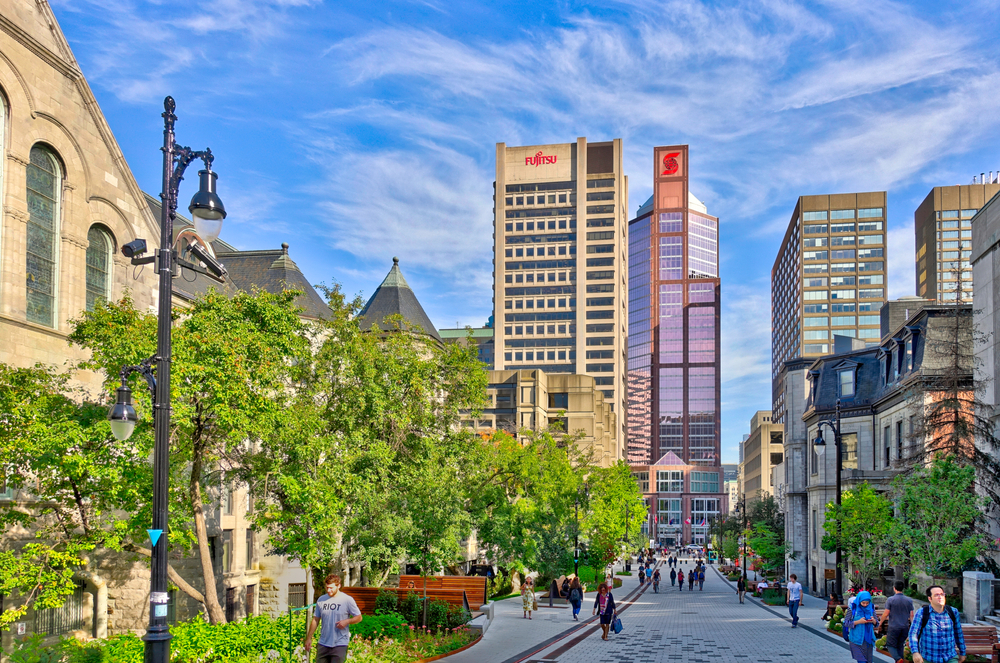 Downtown Montreal pictured on a sunny day with green trees and sunny skies