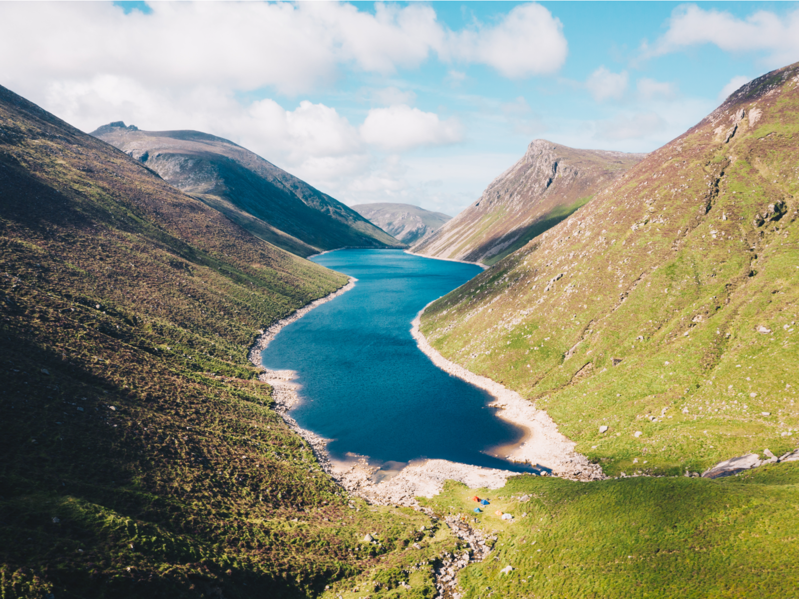 Receding water level of Silent Valley reservoir at a granite mountain range in the Mourne Mountains, one of the best places to visit in Ireland