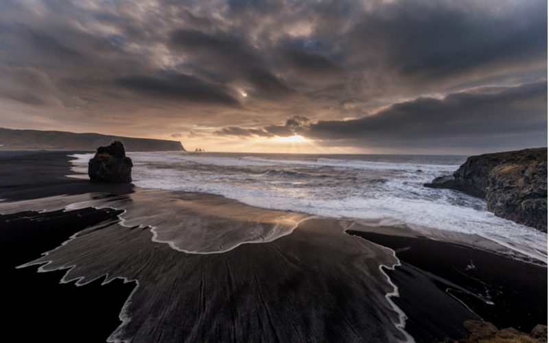 Photo of one of the best things to see in Iceland, Reynisfjara Beach with its black sand and expansive rock formations