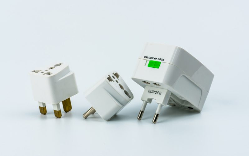 Some of the best travel power adapters sitting in a lightbox