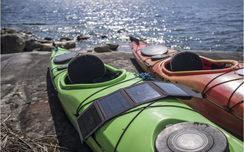 One of the best portable solar panels laying across a kayak