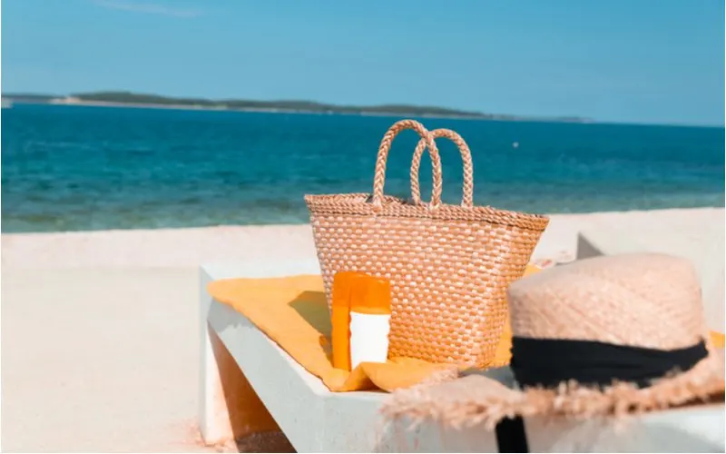 One of the best beach bags sitting on an upholstered chair