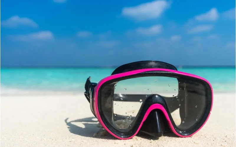 One of the best snorkel masks sitting on a beach