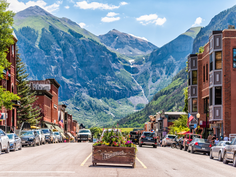 Telluride, one of the best places to visit in Colorado, pictured under a giant mountain