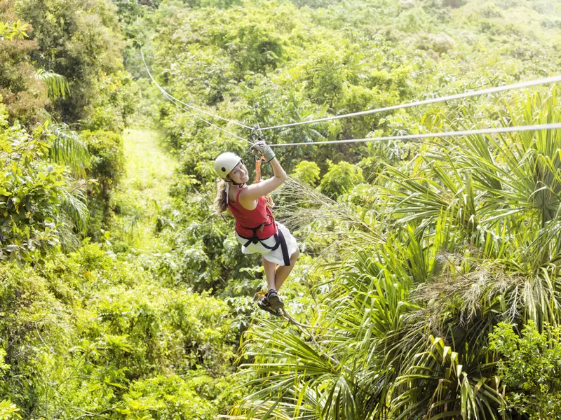 Woman on a jungle zipline at the Mystic Mountain Adventure Park in Ochos Rios, one of the best places to visit in Jamaica