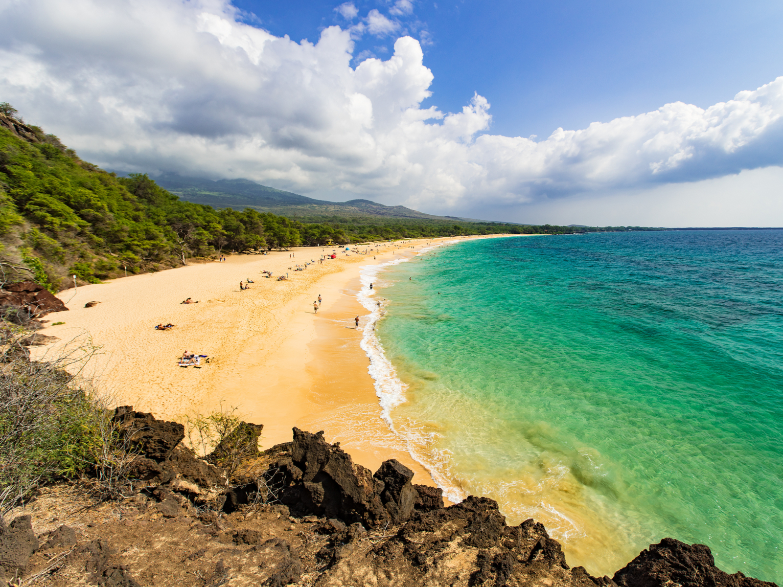 Huge sand beach with few visitors pictured during the least busy time to visit Maui