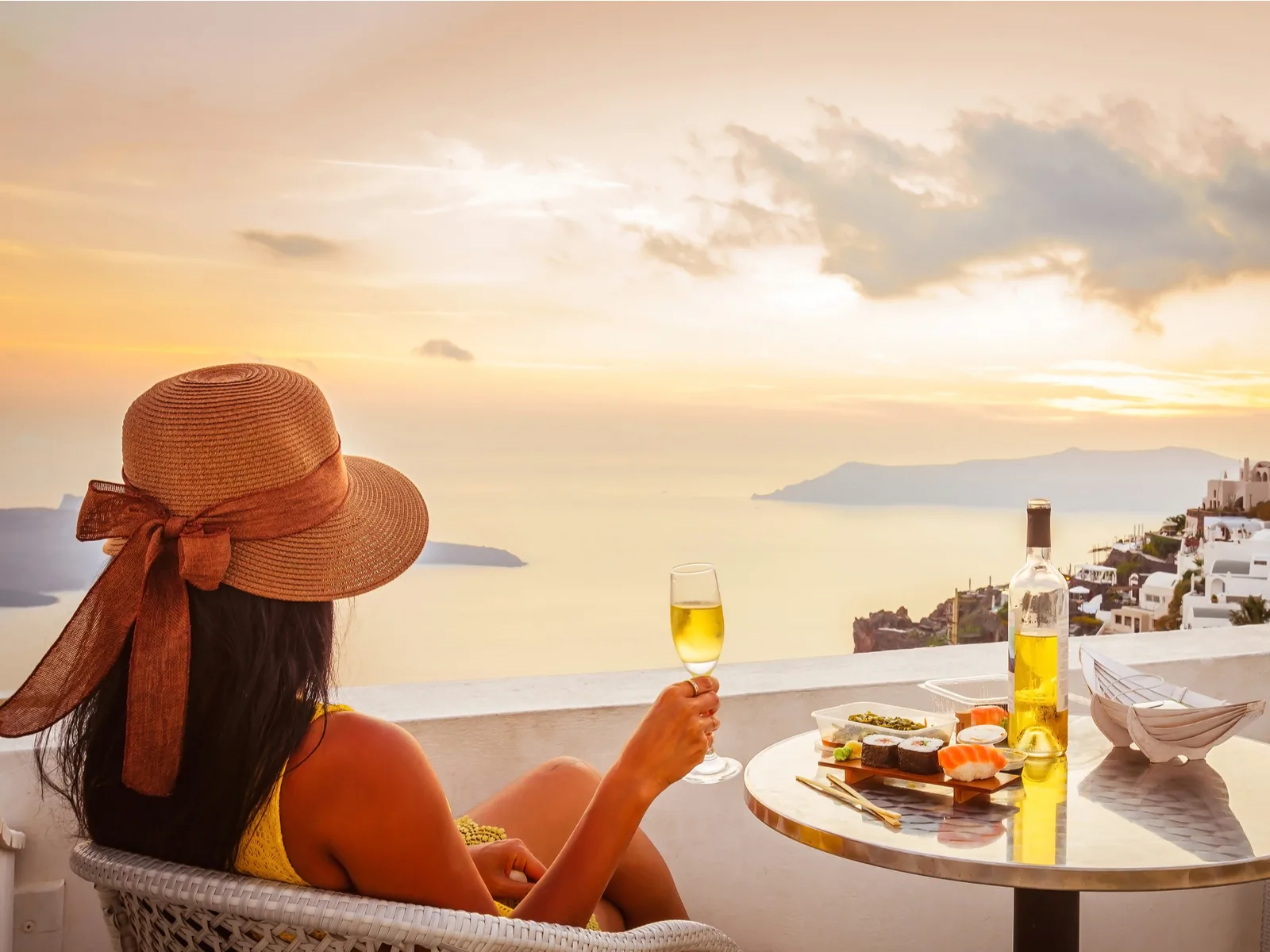 Photo of a woman doing one of the best things to do in Santorini, a wine tour