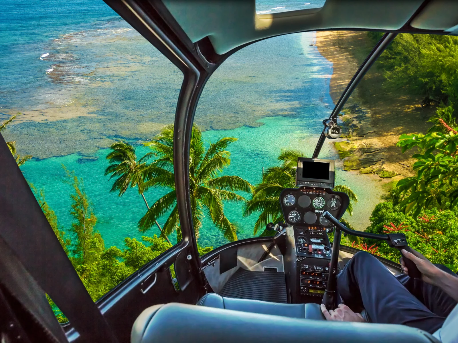 Helicopter flying over Kauai during the best time to visit