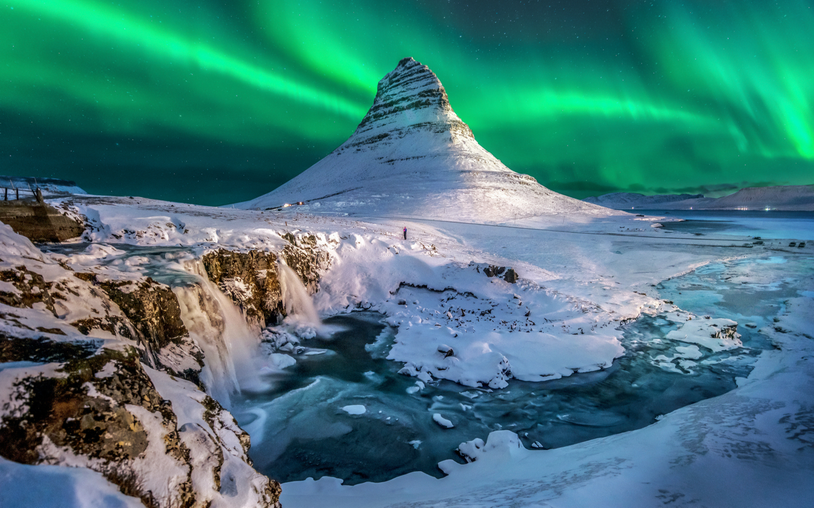 Gorgeous view of the Northern Lights over Mount Kirkjufell for a piece on where to stay in Iceland