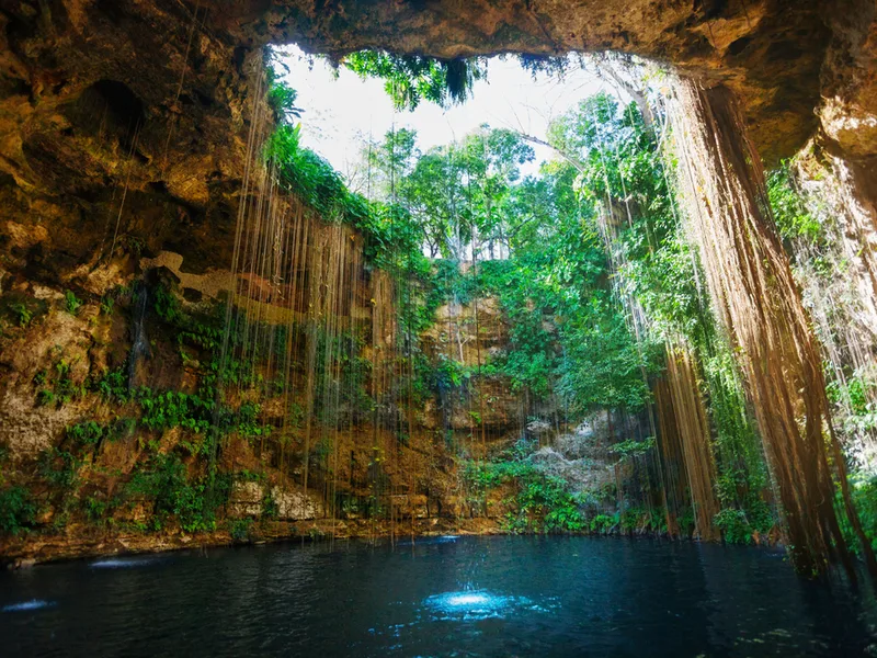 Sunbeams penetrating a Cenote during the best time to visit Mexico