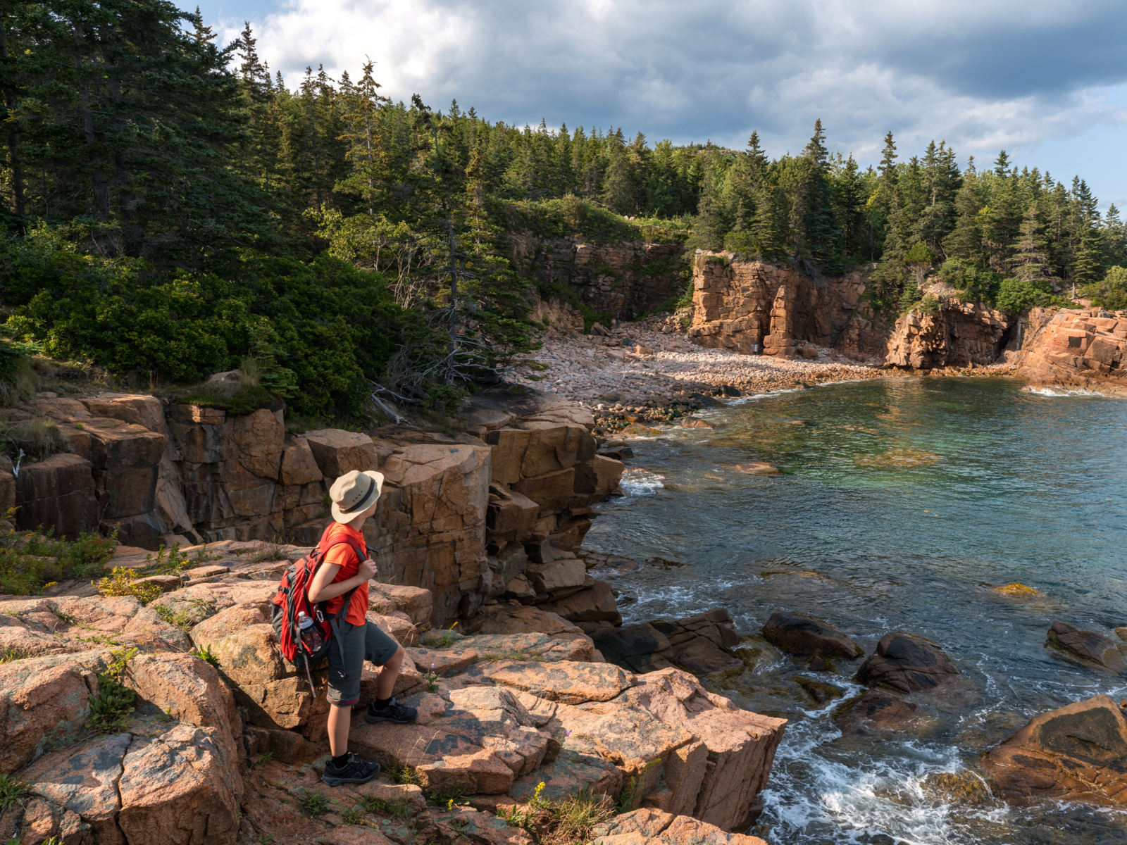 Hiker taking in the views of Acadia National Park during the best time to visit