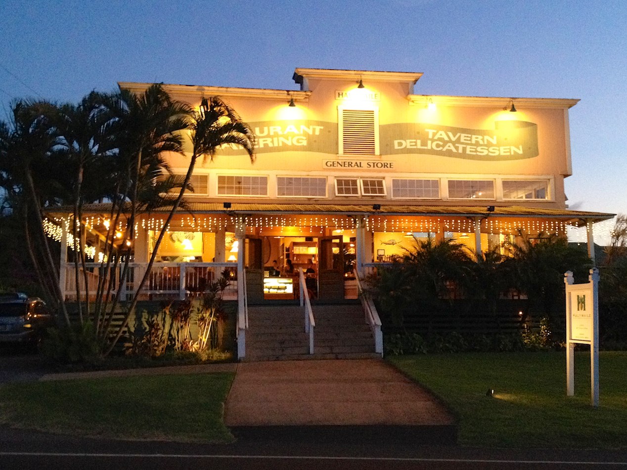 Exterior of Hali’imaile General Store, one of the best restaurants in Maui, Hawaii, at dusk with its attractive lights on its signage and halls