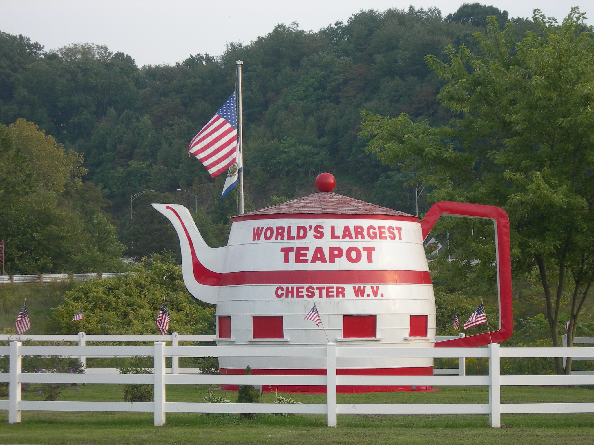 The Chester Teapot named as World’s Largest Teapot is one of the best attractions in West Virginia, fenced inside a green landscape and decorated with the U.S. flag