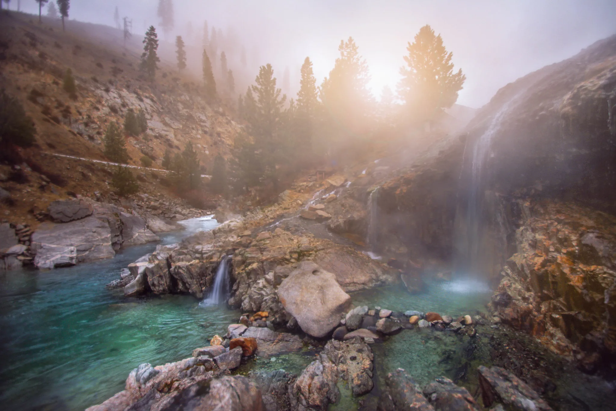 Steamy Kirkham Hot Springs pictured on a bright foggy day as a piece on the best things to see in Idaho