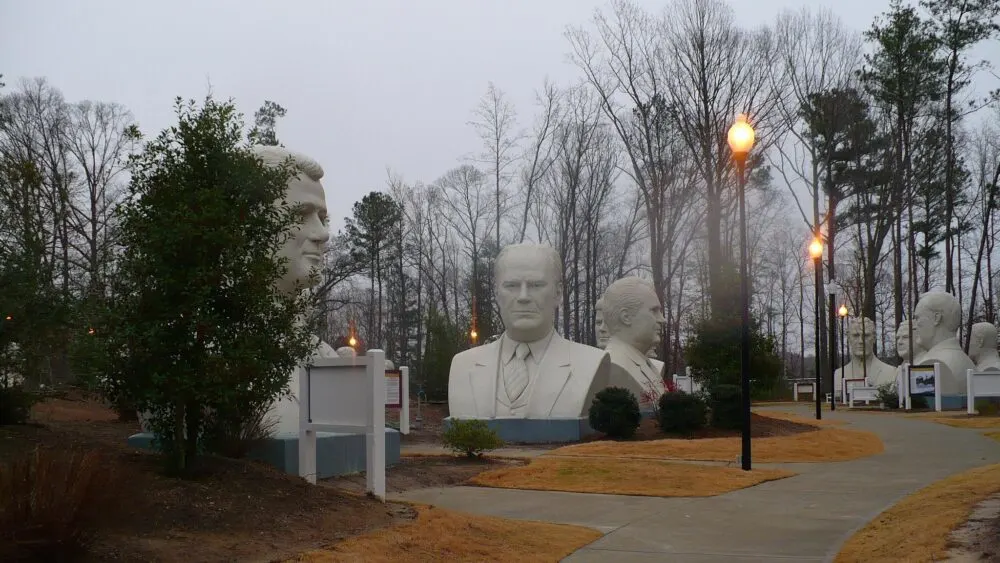 Giant busts of all of the previous presidents of the United States, one of the things to do in Virginia, at The Presidents Park during a gloomy Fall season