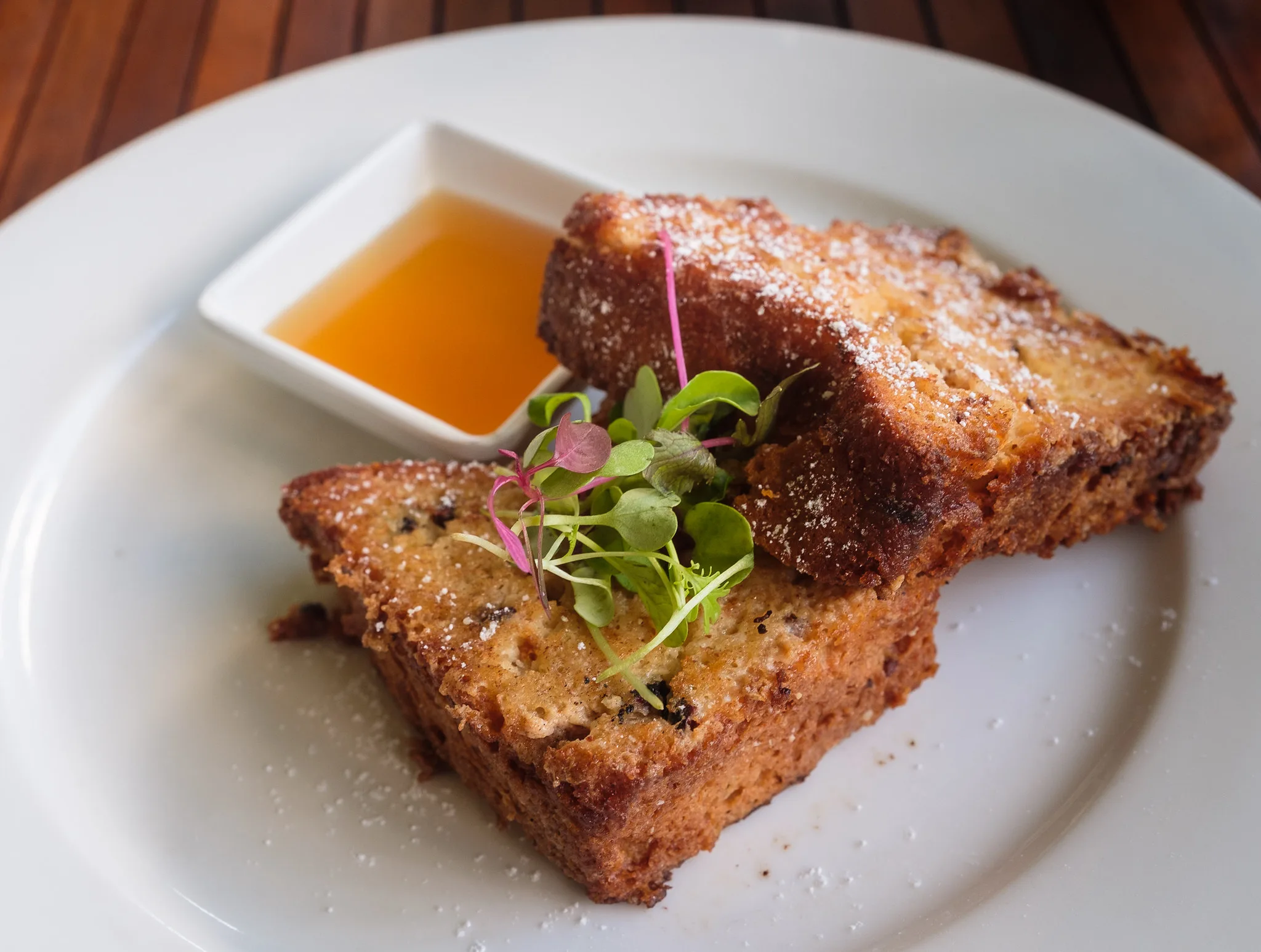 Sweet French Toast with Cinnamon and Honey breakfast served on a white plate at Rabot Restaurant in Chocolate Hotel, a piece on the best restaurants in St. Lucia
