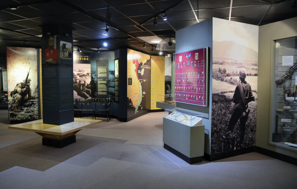 Exhibit of enclosed war medals and images of active soldiers carrying loaded guns are one of the best South Carolina attractions in Parris Island Museum