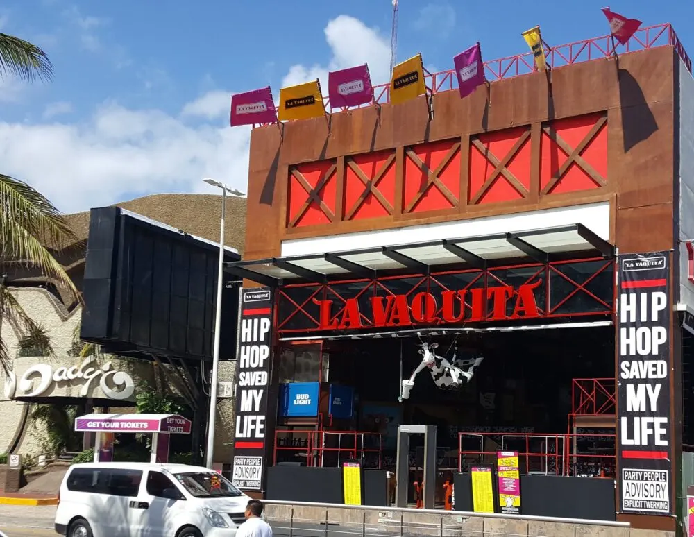 The empty La Vaquita in the morning with its distinct red sign and life-size cow figure hanging by the ceiling, one of the best clubs in Cancun