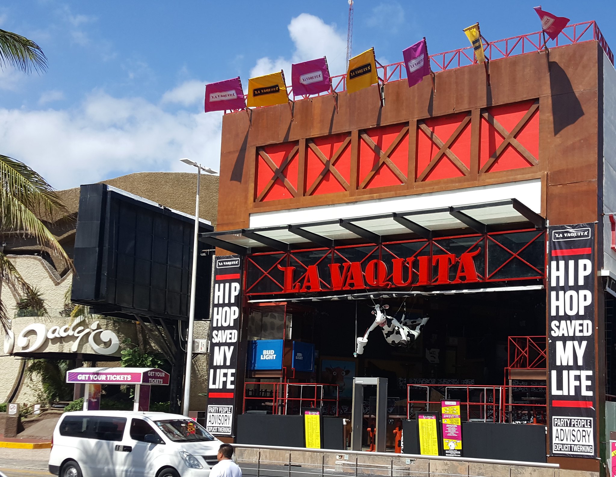 The empty La Vaquita in the morning with its distinct red sign and life-size cow figure hanging by the ceiling, one of the best clubs in Cancun