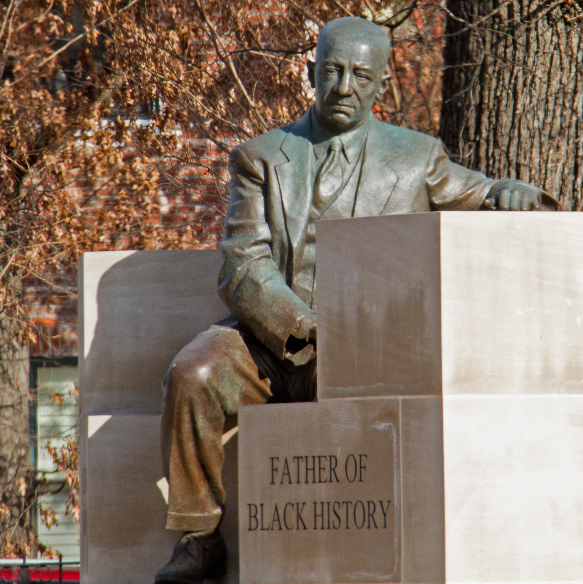 Historic statue of The Father of Black History on a sitting position, one of the best attractions in West Virginia, at Carter G. Woodson Memorial Park
