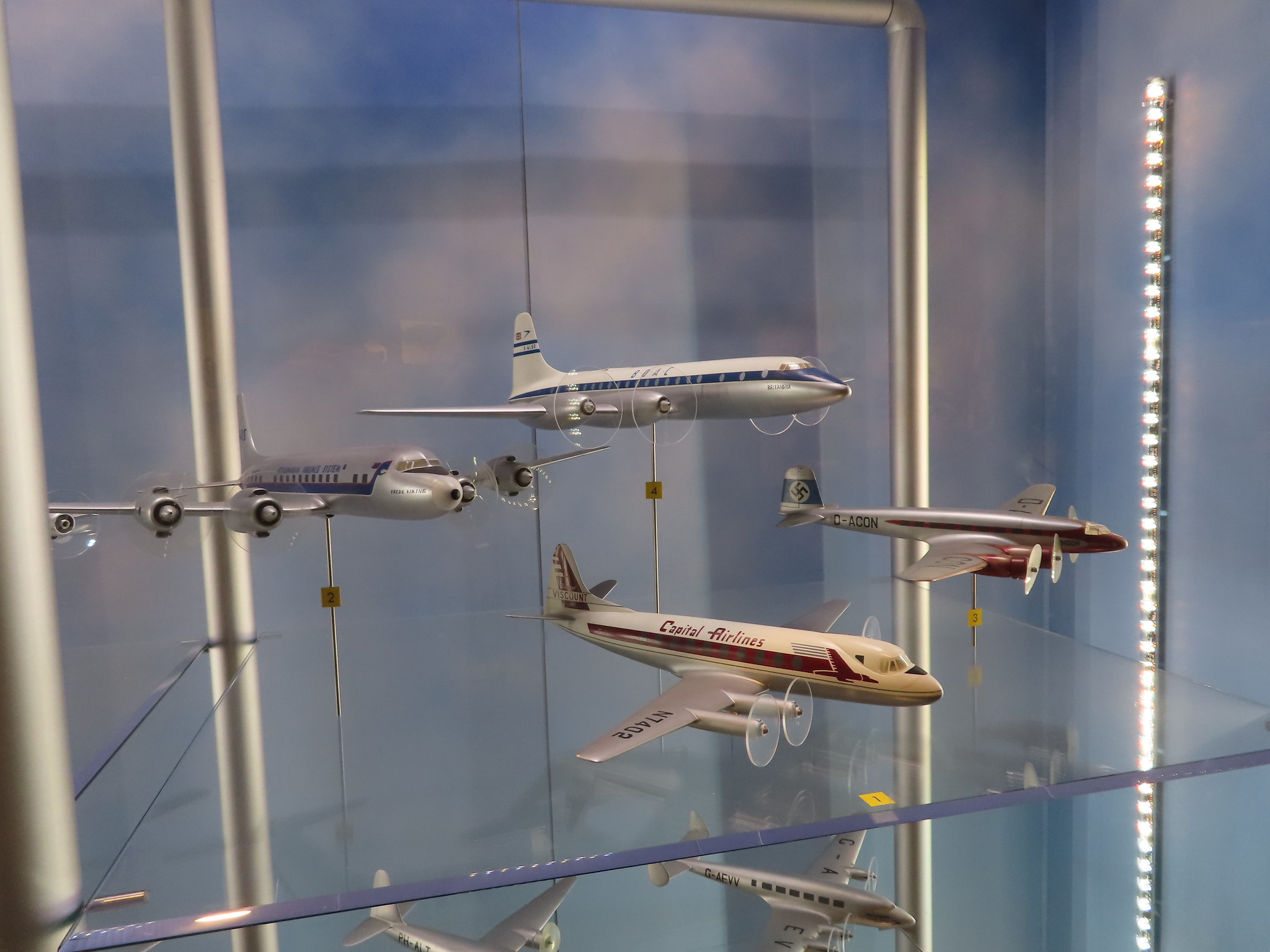 Miniature models of airplanes used the by the military exhibited in a shelf at The National Museum of the U.S. Air Force, a piece on the best things to do in Ohio