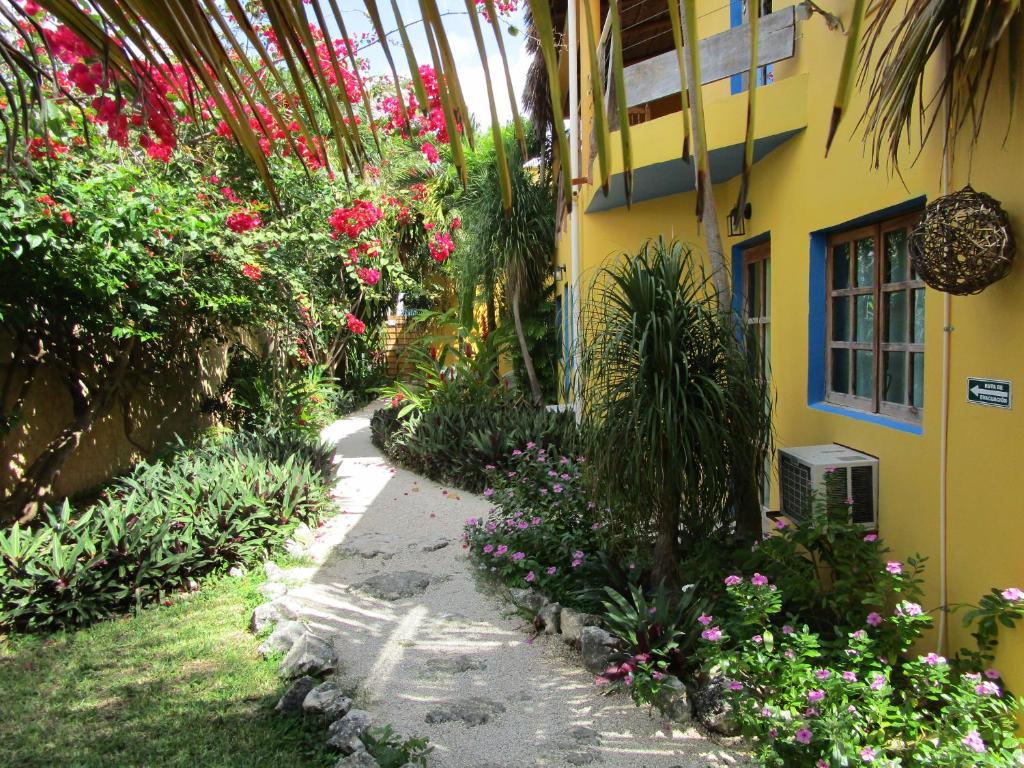 Casa Abanico, one of the best hotels in Tulum, pictured from the gravel walking path outside