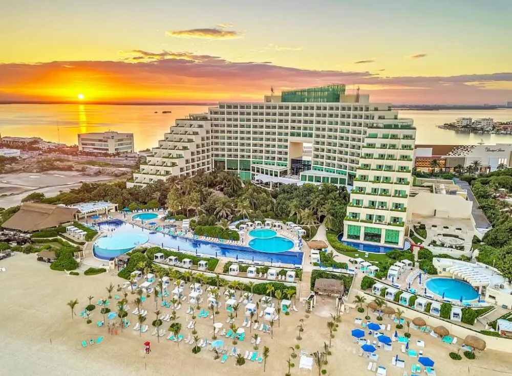 Live Aqua Beach Resort, one of the best all-inclusive resorts in Cancun, pictured above showing the beach and pool and building at sunset