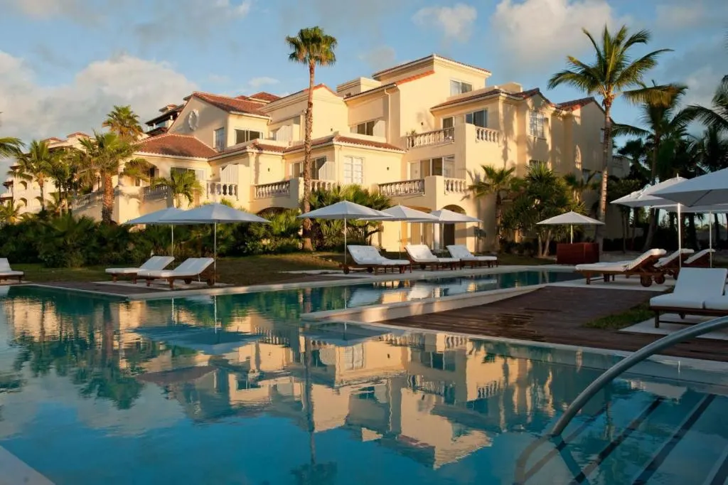 Neat pool and villas overlooking the water at Grace Bay Club, one of the best resorts in Turks and Caicos