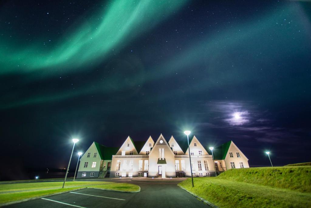 Northern lights above the Héradsskólinn Historic Guesthouse for a piece on the best hotels in Iceland