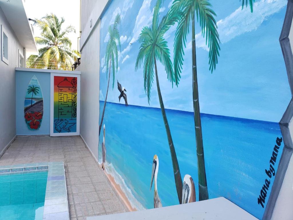 Palmeras Del Mar, one of the best hotels in Puerto Rico, pictured between the pool and the front door with a mural on the wall
