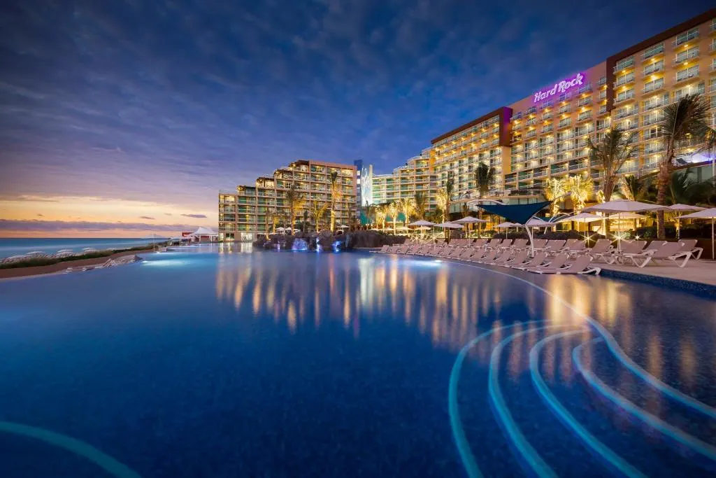 Pool view of one of the best all-inclusive resorts in Cancun, the Hard Rock Hotel, at night