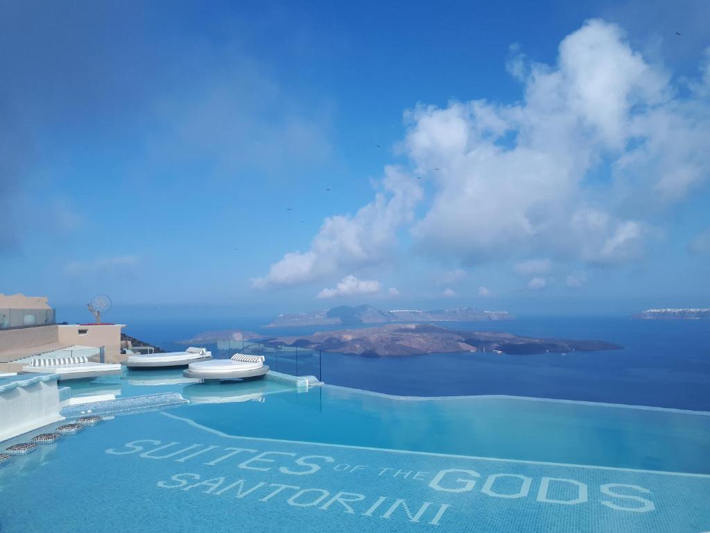 Suites of the Gods Cave Spa Hotel infinity pool overlooking the ocean for a piece on the best hotels in Santorini