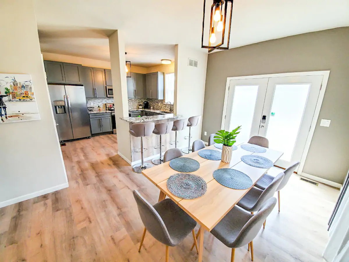 The dining area with a kitchen counter and vinyl floor at Downtown St. Louis Home, considered one of the best bachelorette Airbnbs