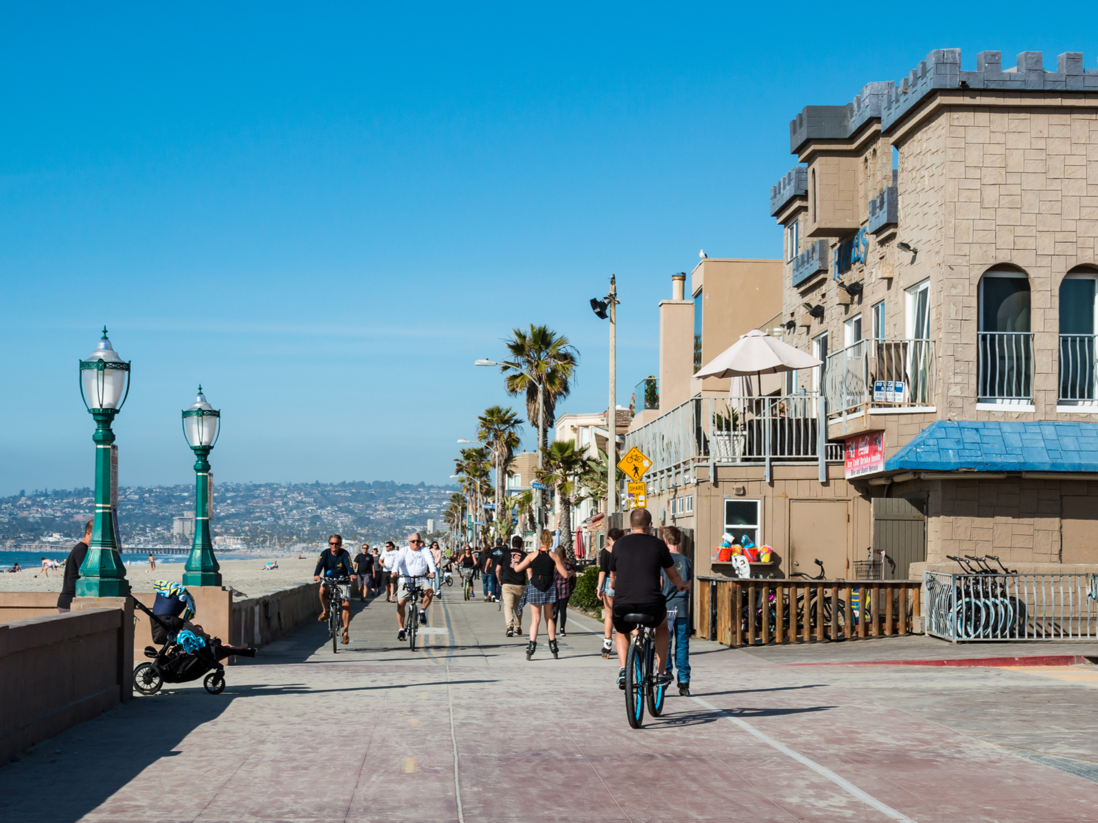 People riding bikes in the Mission Beach area, one of our picks for where to stay in San Diego