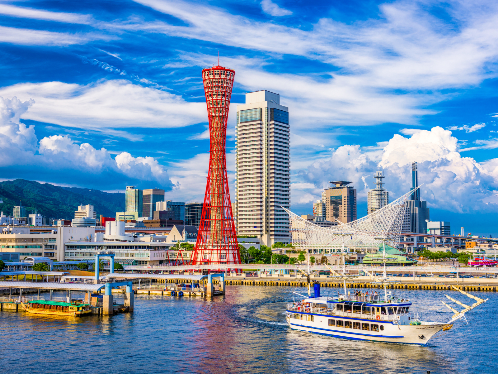 Water view of Kobe, a must-visit place in Japan, on a clear day with only a few clouds in the sky