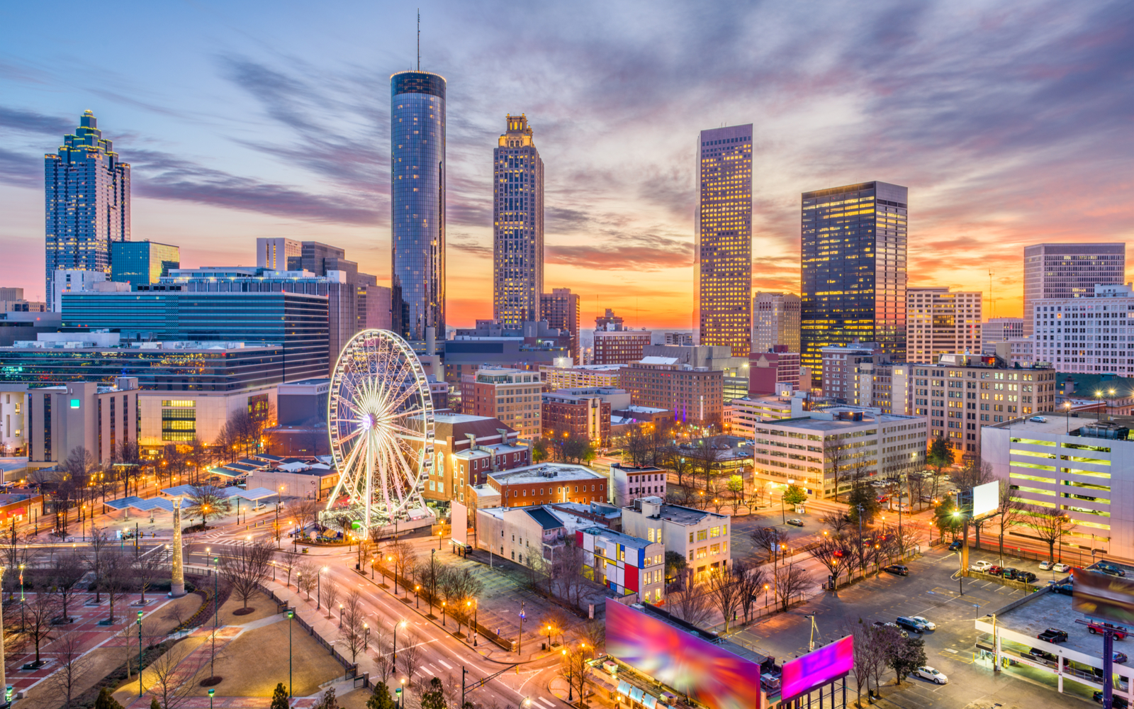 Featured image for a piece on the best hotels in Atlanta featuring a dusk shot of the downtown skyline