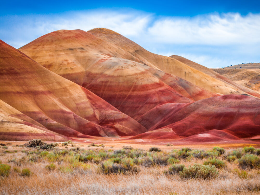 Dawn view of gorgeous red Painted Hills made of clay, one of Oregon's best places to visit