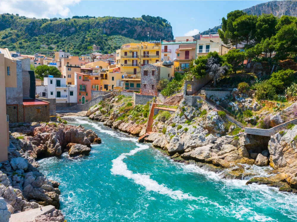 Santa Flavia pictured during the cheapest time to visit Italy with a gorgeous river flowing through the town
