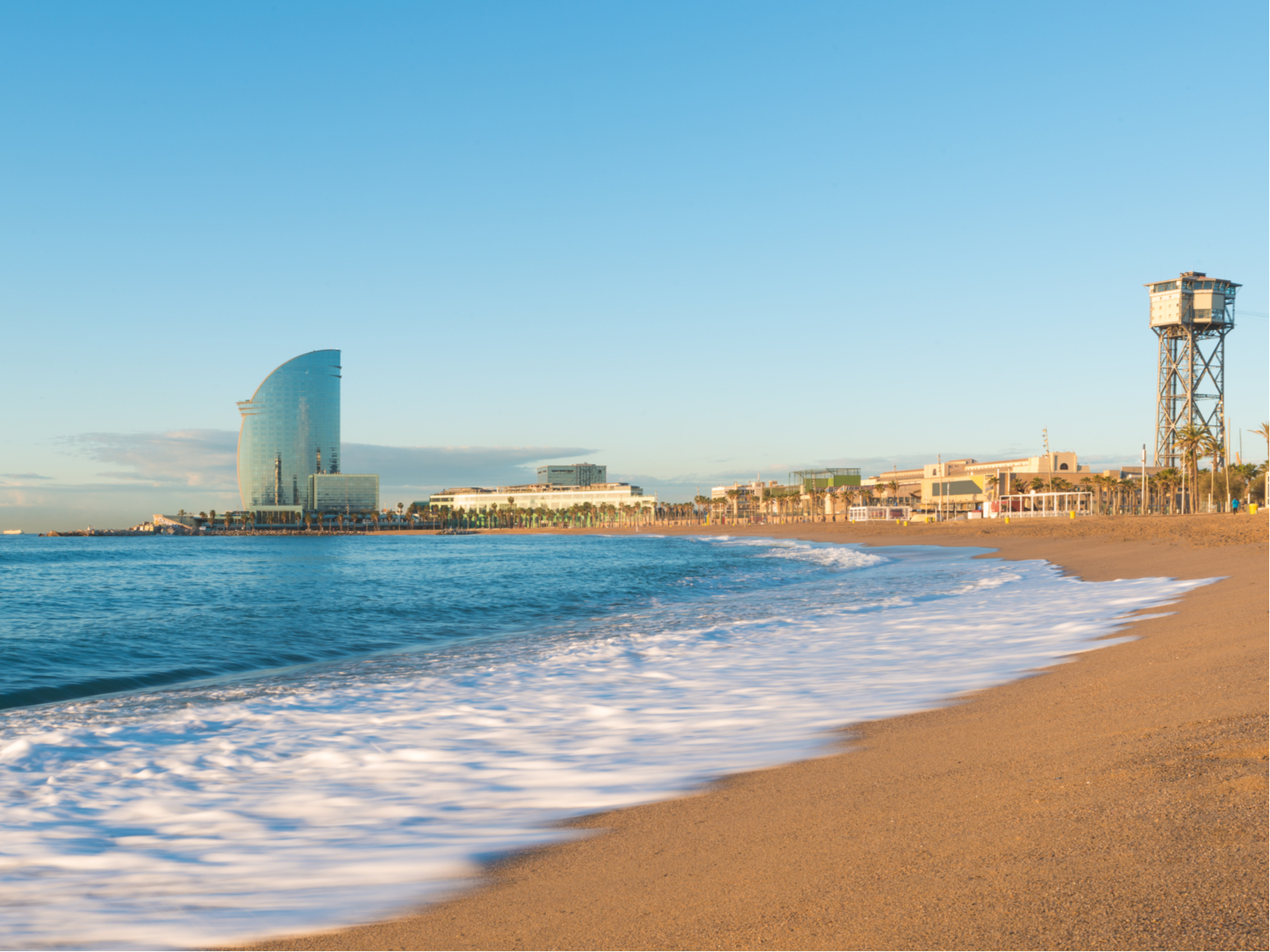 Photo of a gorgeous brown sand beach during the best time to visit Barcelona