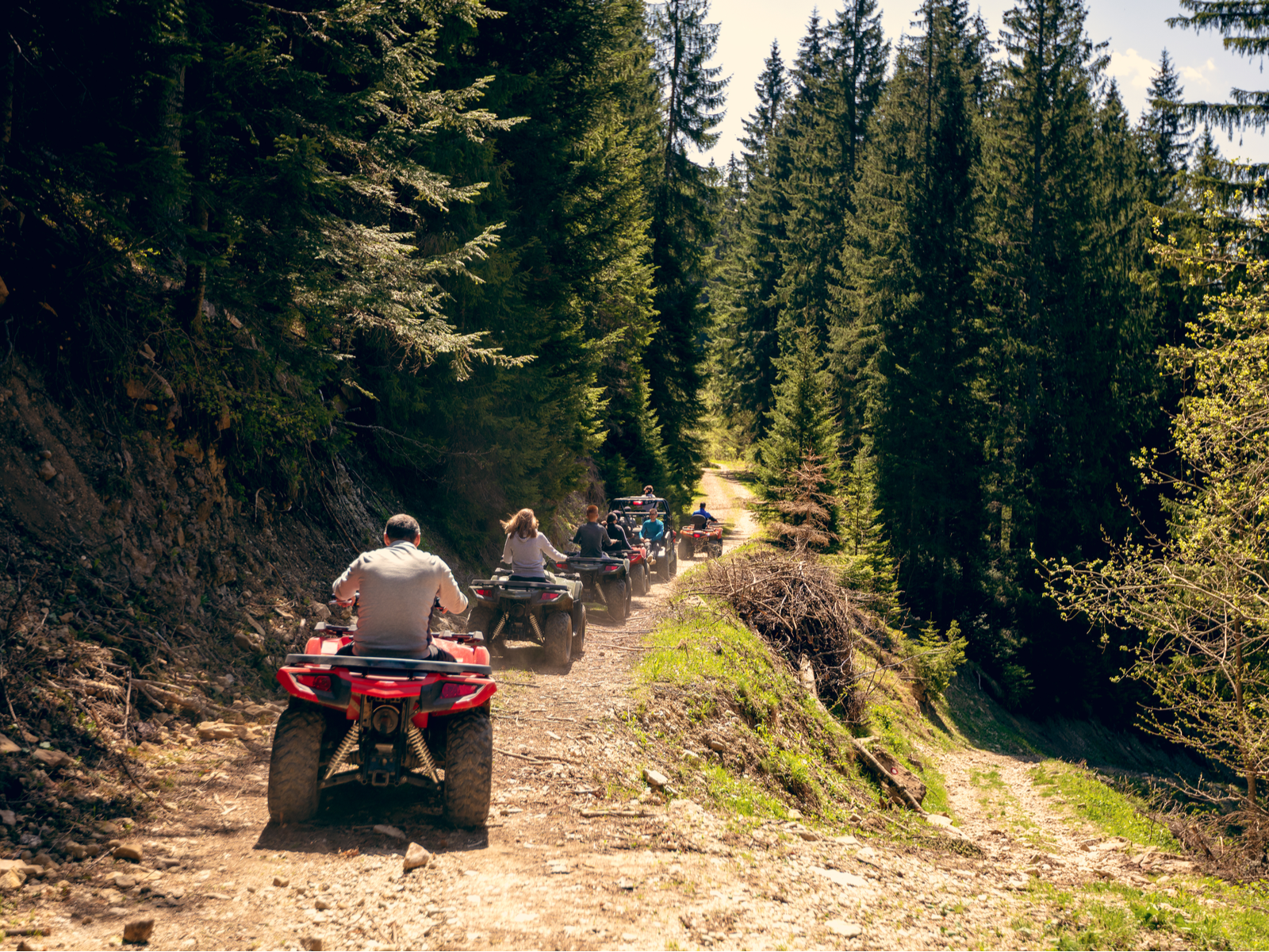 Group of friends riding ATVs up a mountain trail, pictured as a piece on the best things to do in Costa Rica