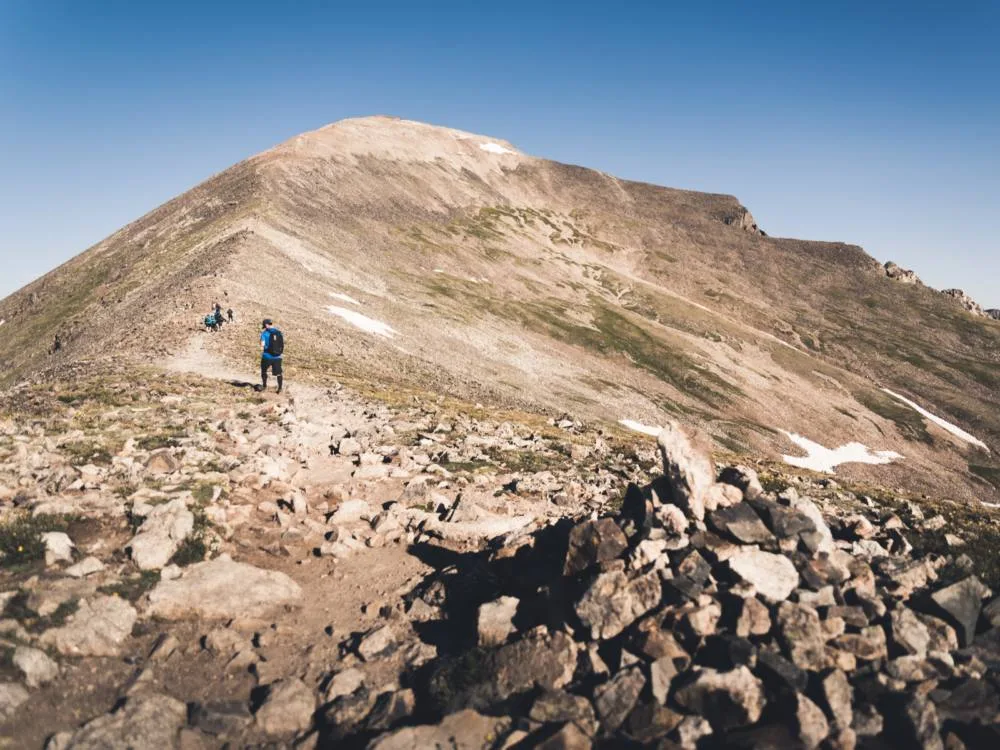 Guy climbing Quandary peak, one of the best hikes near Denver, Colorado