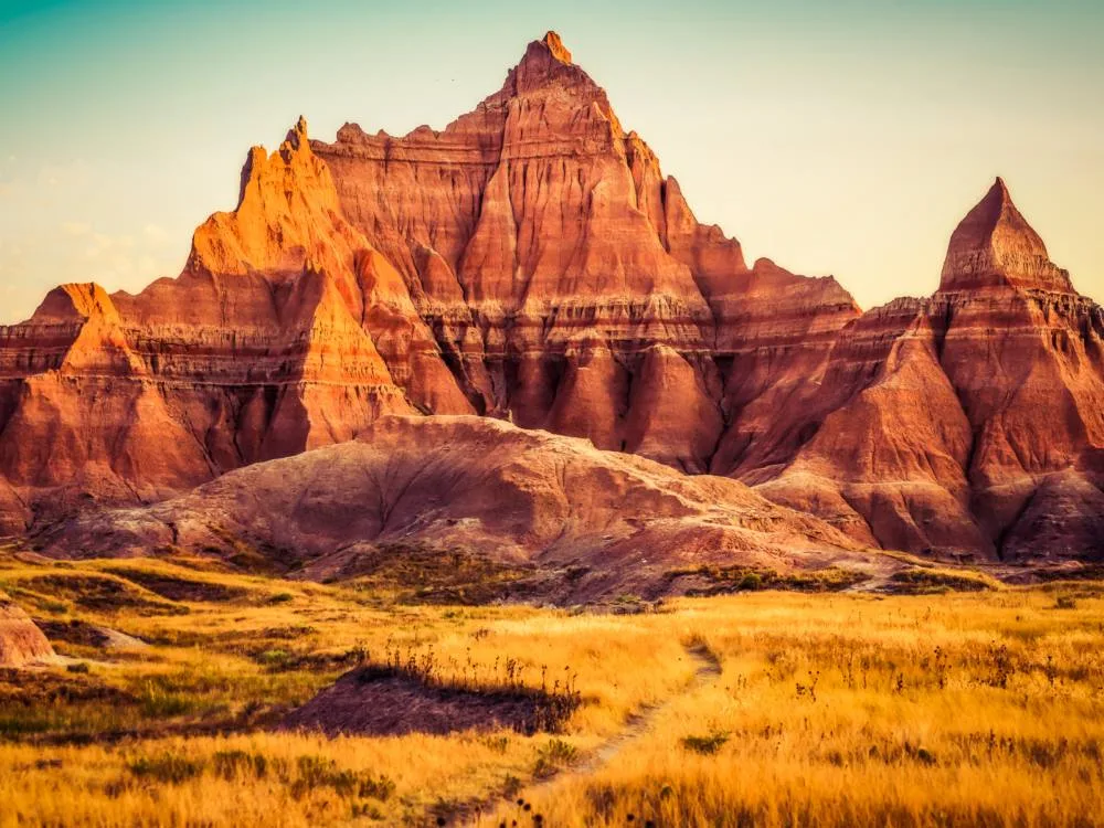 A scenic view of natural landscapes, one of the best South Dakota tourist attractions, at Badlands National Park on a sunset