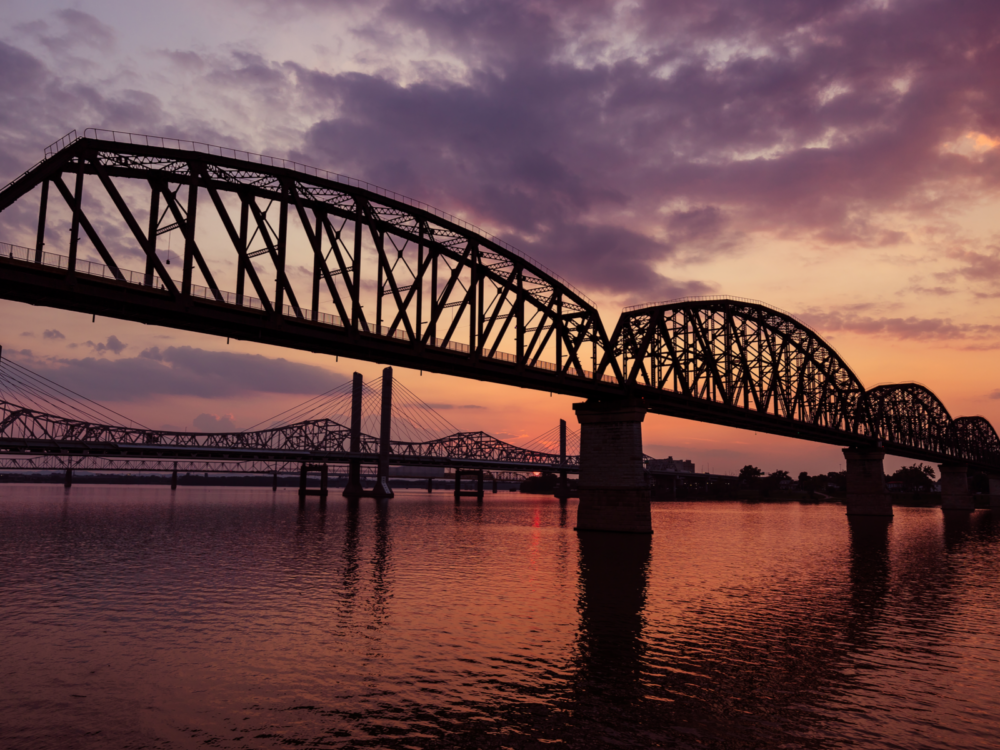 Crimson sunset over The Big Four Bridge, one of the best things to do in Kentucky, known to connect Kentucky and Indiana across the Ohio River