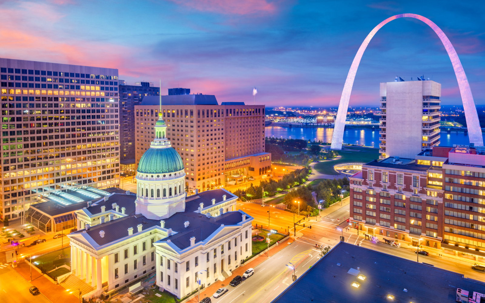 Cool featured image of some of the best things to do in St. Louis, the Arch and downtown pictured at night