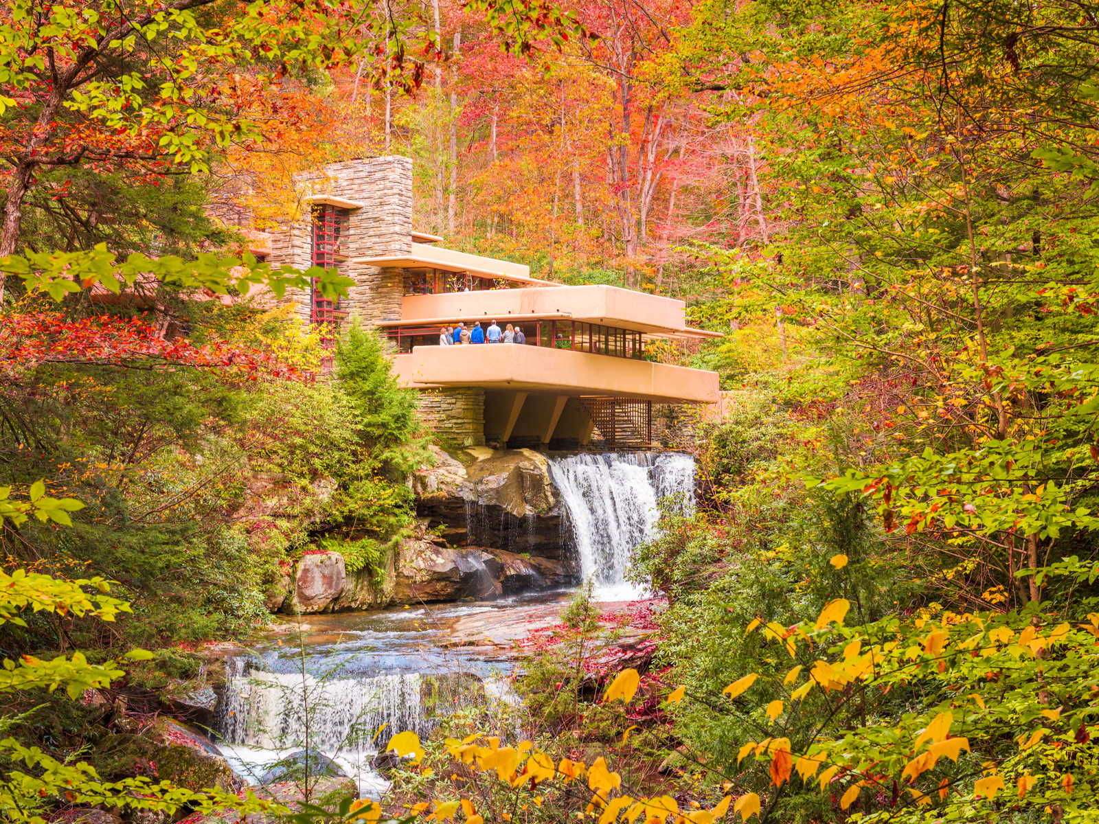 A group of people having a meeting at the unique architecture of Fallingwater over Bear Run Nature Reserve, as one of the best things to do in Pennsylvania