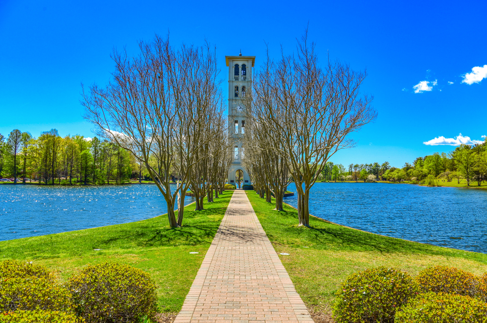 Furman Swan Lake and bell tower in the distance on a spring day with blue skies in Travelers Rest, one of our favorite attractions in South Carolina