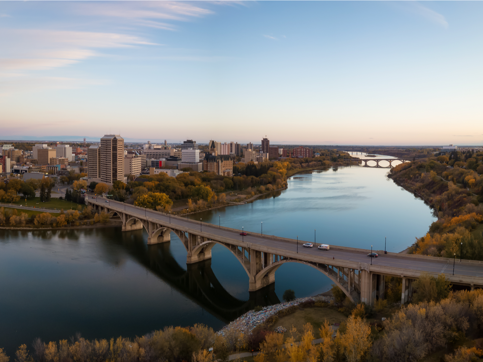 Panoramic view of Saskatoon Skyline and bridges going over the Saskatchewan River in an early morning, one of the best places to visit in Canada