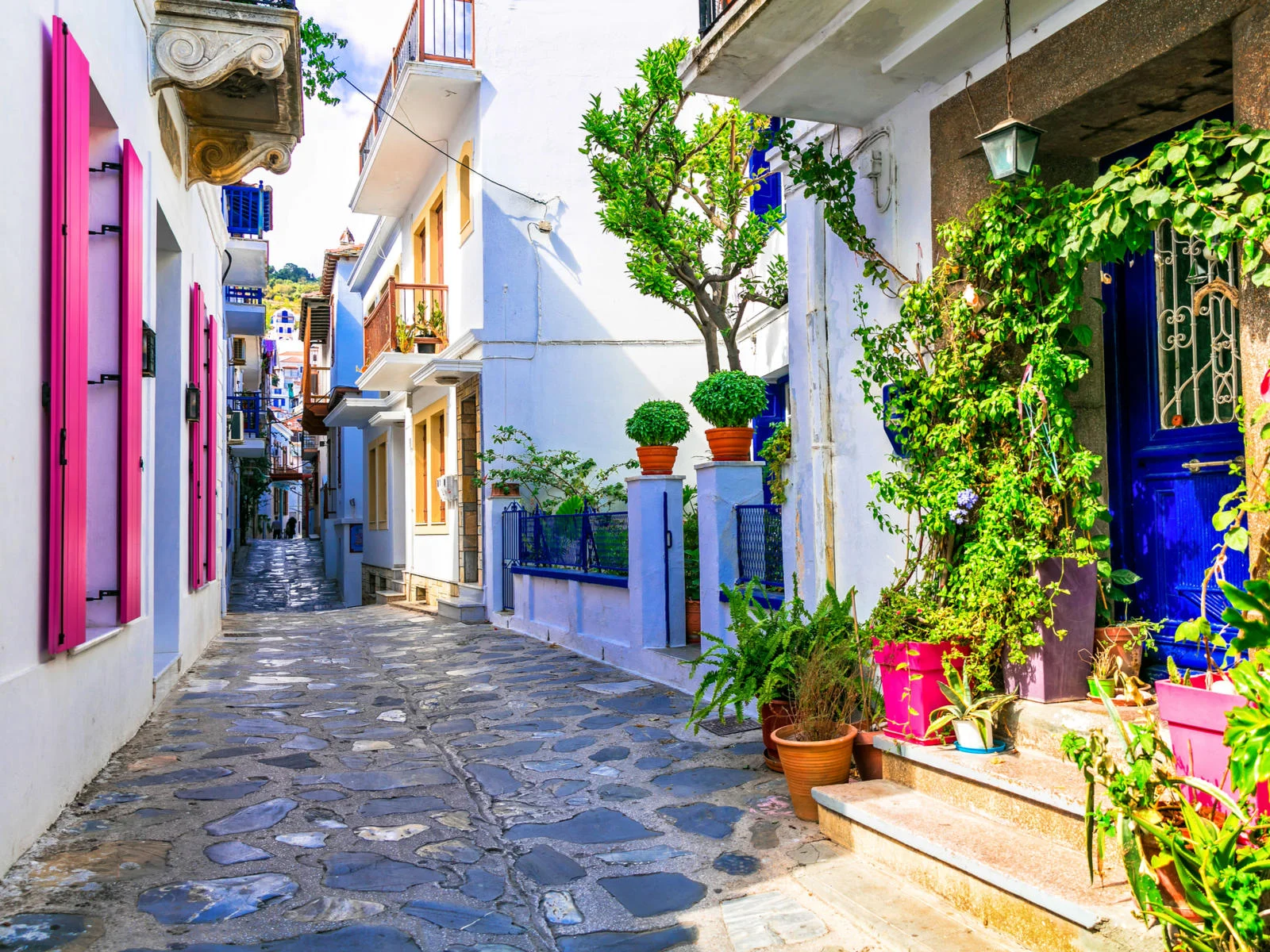 A peaceful and vibrant alley at a town in one of the best islands in Greece to visit, Skopelos Island 