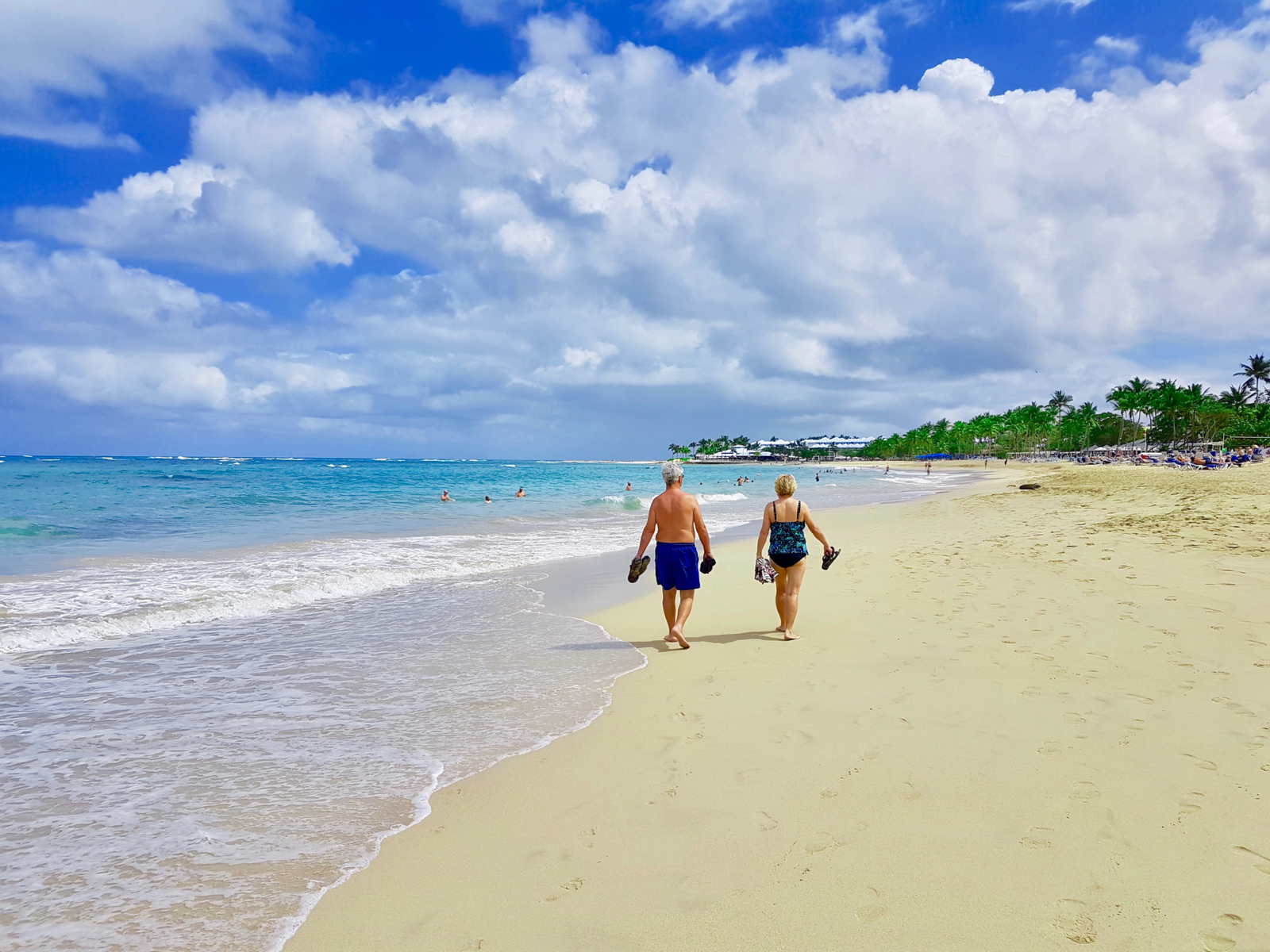 Older couple walking on the beach at one of the best places to visit in the Dominican Republic, Playa Dorada